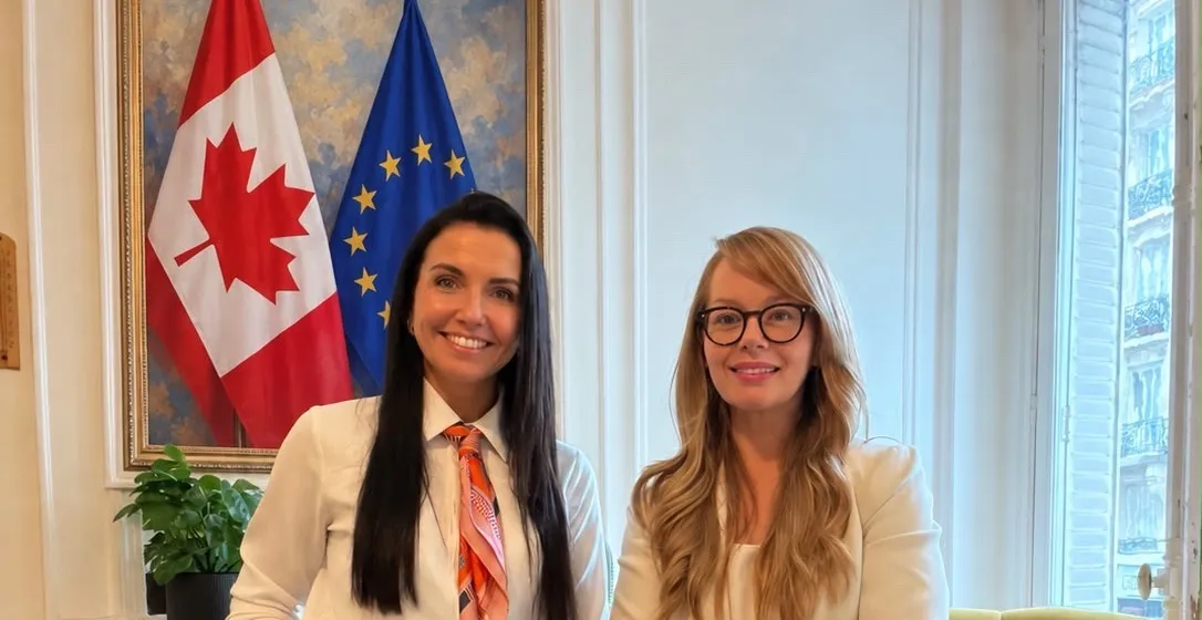 Kätlin Koemets of Cyberr and Anne Patterson of ICTC in Paris, in front of the Canadian and European Union flags